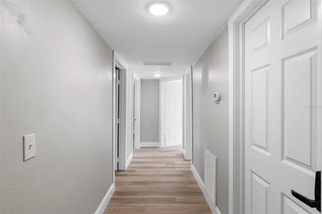 a view of an empty room and wooden floor
