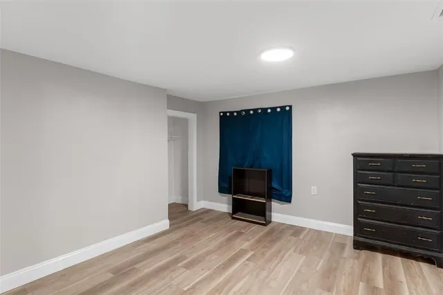 a bathroom with a granite countertop toilet sink and mirror