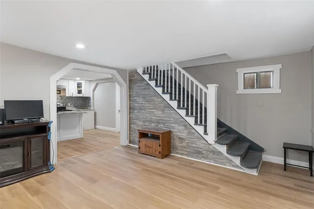 a view of a kitchen with wooden floor and electronic appliances