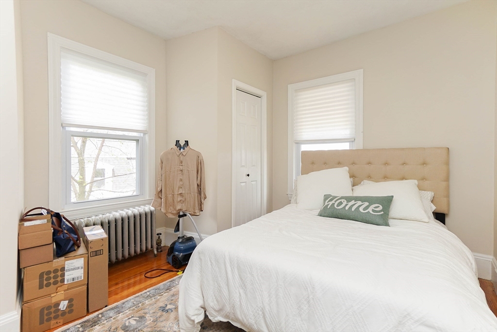 51 Main Street, Unit 2 Somerville, MA 02145 - Photo 11 of 23 a bedroom with a bed and wooden floor