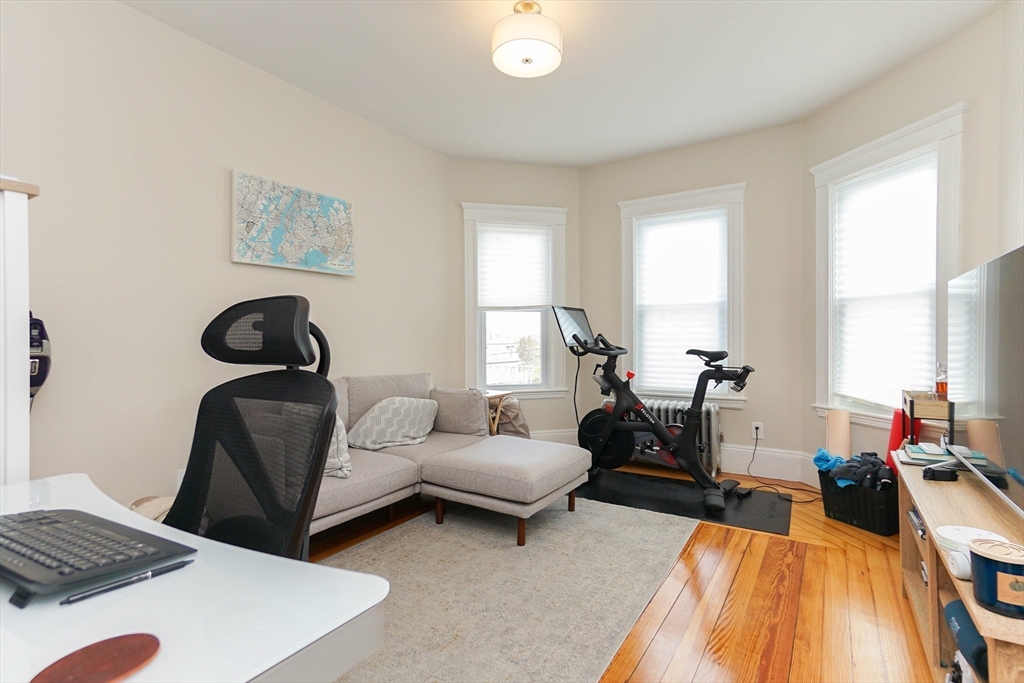 51 Main Street, Unit 2 Somerville, MA 02145 - Photo 12 of 23 a bedroom with a bed and a chair