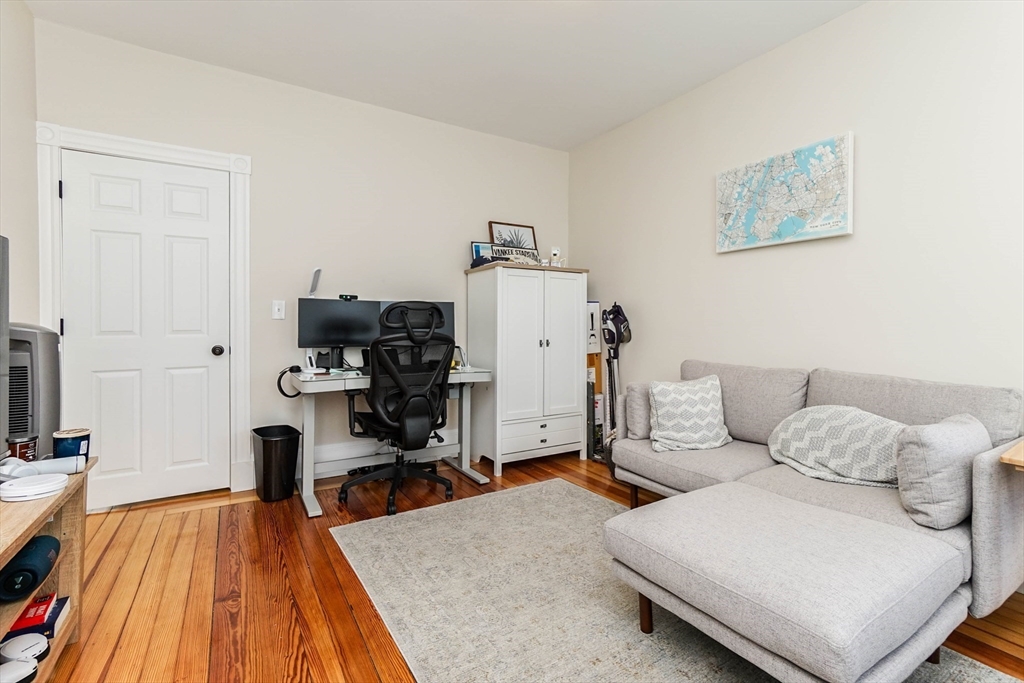 51 Main Street, Unit 2 Somerville, MA 02145 - Photo 15 of 23 a living room with furniture and a wooden floor