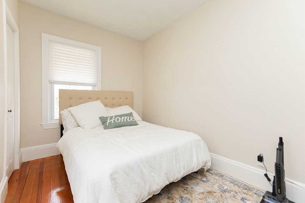 51 Main Street, Unit 2 Somerville, MA 02145 - Photo 16 of 23 a bedroom with a bed and a rug