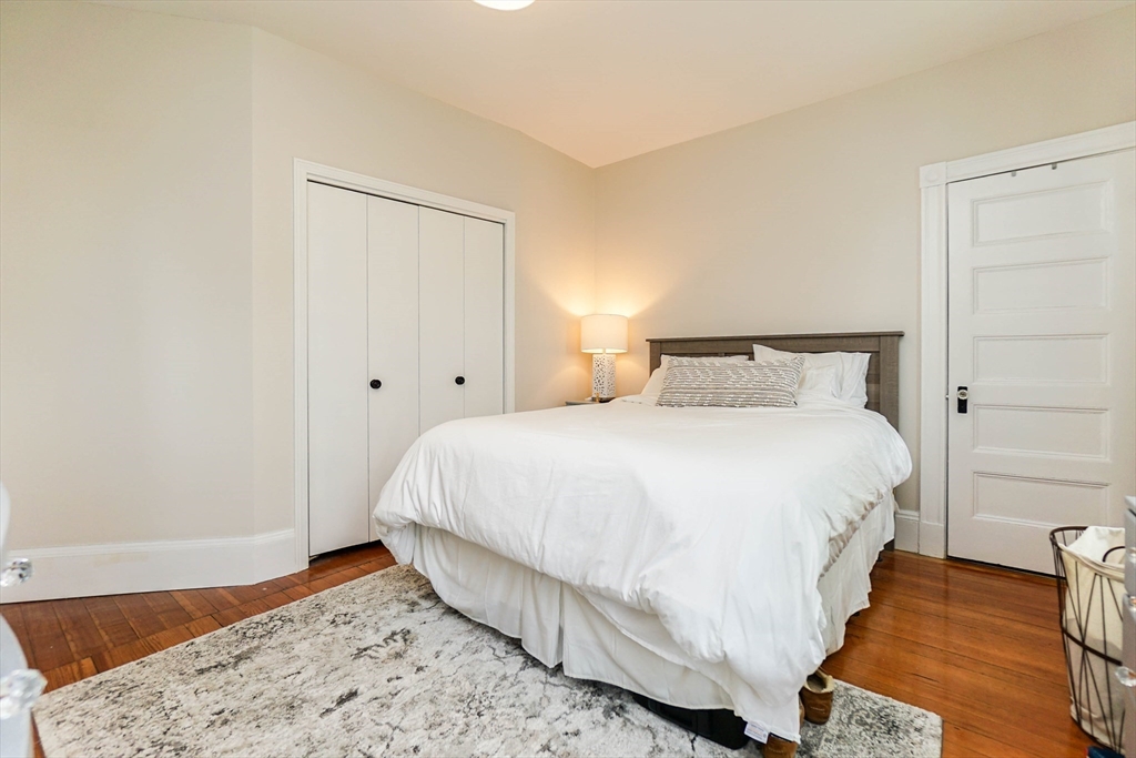 51 Main Street, Unit 2 Somerville, MA 02145 - Photo 17 of 23 a bedroom with a bed and wooden floor