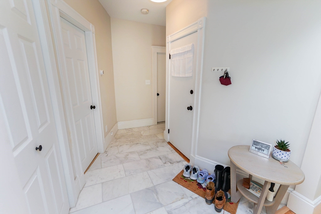 51 Main Street, Unit 2 Somerville, MA 02145 - Photo 18 of 23 a view of a hallway with furniture and wooden floor