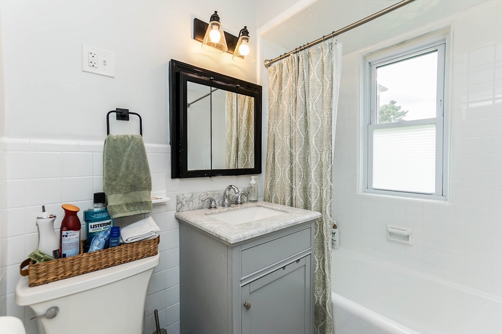 51 Main Street, Unit 2 Somerville, MA 02145 - Photo 21 of 23 a bathroom with a sink vanity granite tub and a mirror