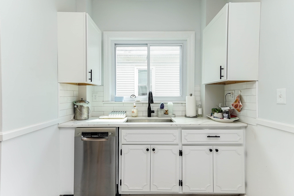 51 Main Street, Unit 2 Somerville, MA 02145 - Photo 5 of 23 a kitchen with white cabinets and a window