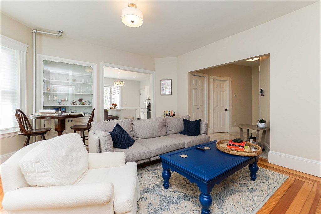 51 Main Street, Unit 2 Somerville, MA 02145 - Photo 7 of 23 a living room with furniture and a wooden floor