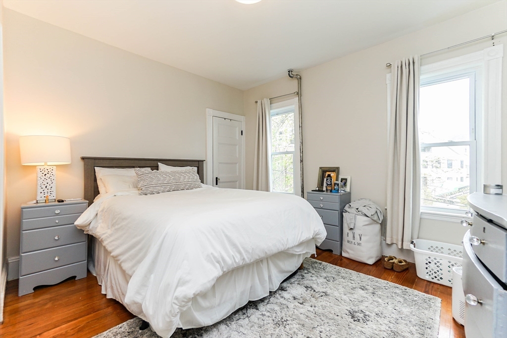 51 Main Street, Unit 2 Somerville, MA 02145 - Photo 10 of 23 a bedroom with a bed and wooden floor