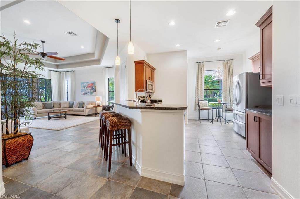 7563 Moorgate Point Way Naples, FL 34113 - Photo 11 of 50 a lobby with furniture and a flat screen tv
