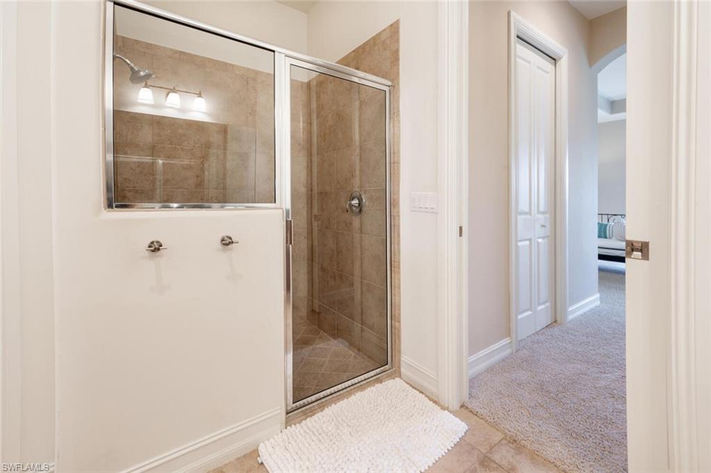 7563 Moorgate Point Way Naples, FL 34113 - Photo 17 of 50 a view of a bathroom with a glass shower door