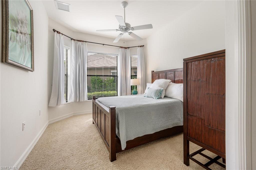7563 Moorgate Point Way Naples, FL 34113 - Photo 18 of 50 a bedroom with a bed and a window