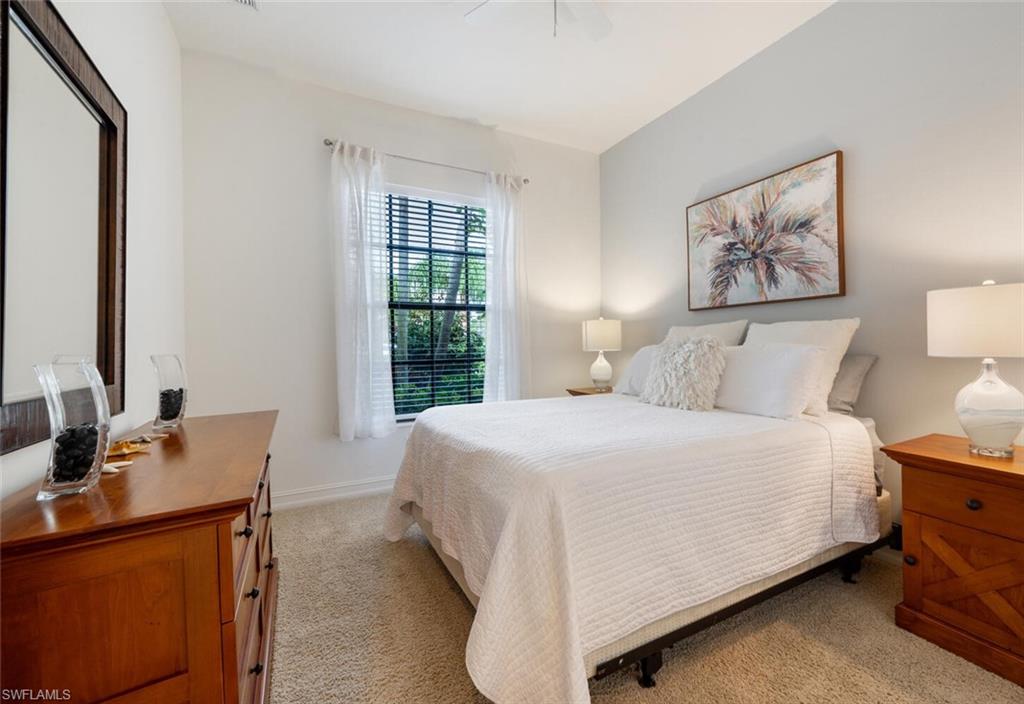 7563 Moorgate Point Way Naples, FL 34113 - Photo 20 of 50 a bedroom with a bed and wooden floor