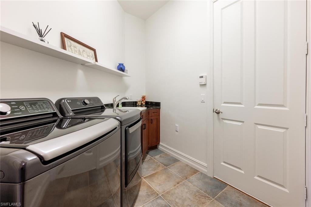 7563 Moorgate Point Way Naples, FL 34113 - Photo 21 of 50 a utility room with dryer and washer