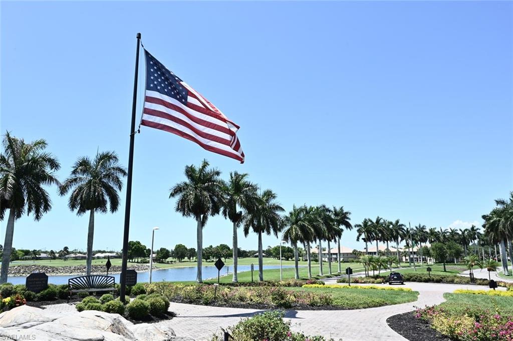 7563 Moorgate Point Way Naples, FL 34113 - Photo 49 of 50 a front view of a house with a yard and palm trees