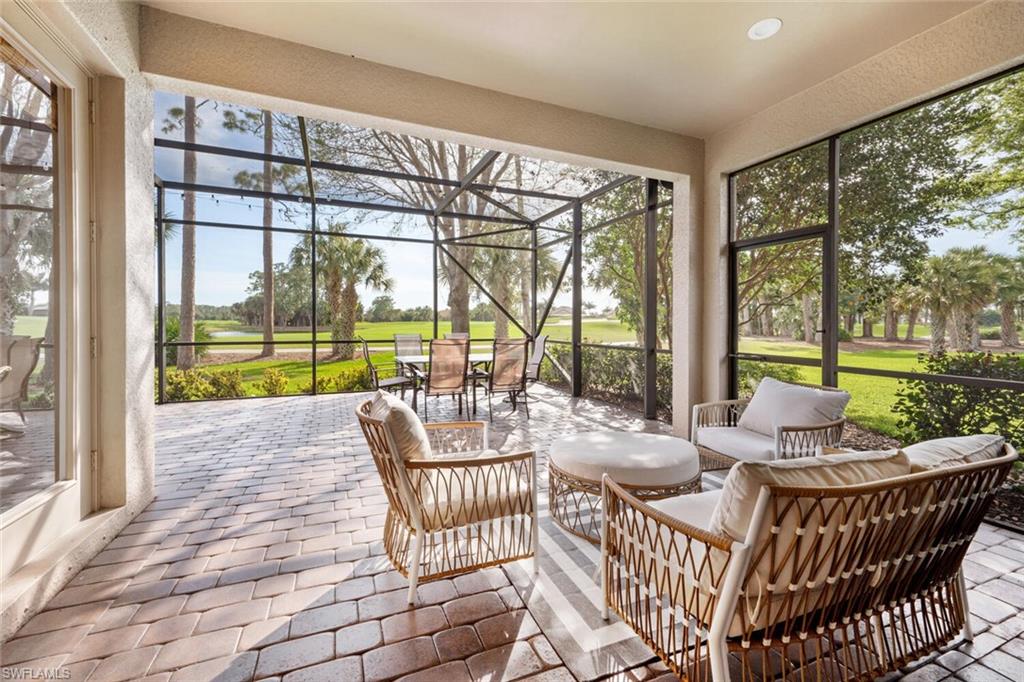 7563 Moorgate Point Way Naples, FL 34113 - Photo 5 of 50 a living room with furniture and a floor to ceiling window