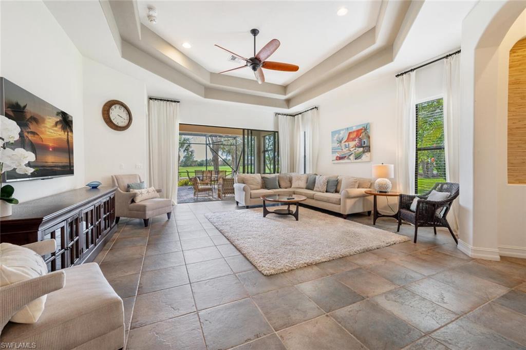 7563 Moorgate Point Way Naples, FL 34113 - Photo 8 of 50 a living room with furniture and a large window