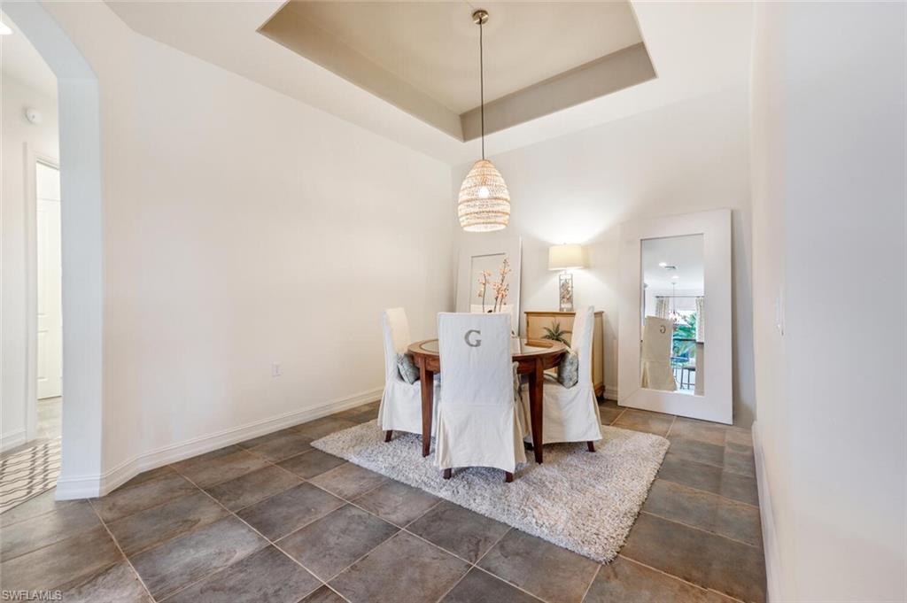 7563 Moorgate Point Way Naples, FL 34113 - Photo 10 of 50 a view of a hallway with white walls and chandelier