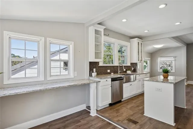 a kitchen with a sink stove and cabinets