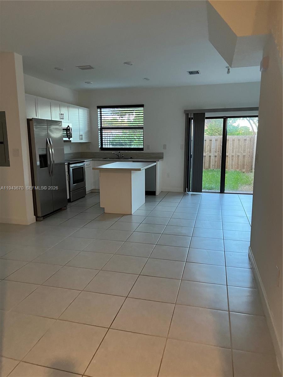a kitchen with stainless steel appliances a refrigerator and microwave