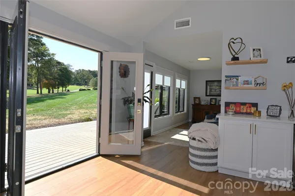 a living room with rug floor and a floor to ceiling window