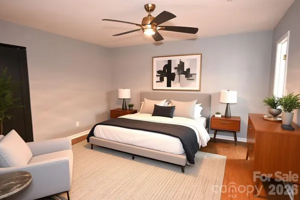 a bedroom with a bed couch and window