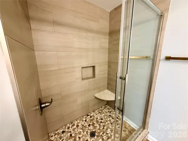 a bathroom with a toilet and a shower