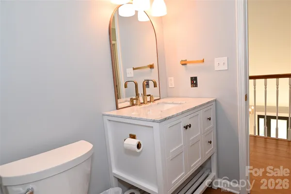 a bathroom with a sink a toilet and a mirror