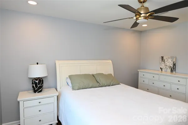 a bedroom with a bed and a table in it