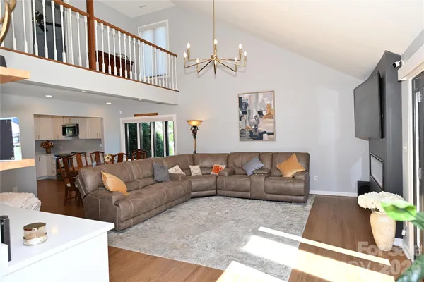 a living room with furniture and a chandelier