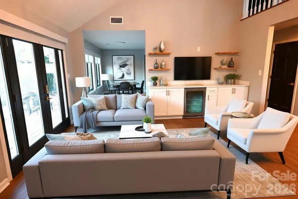 a living room with furniture and a flat screen tv