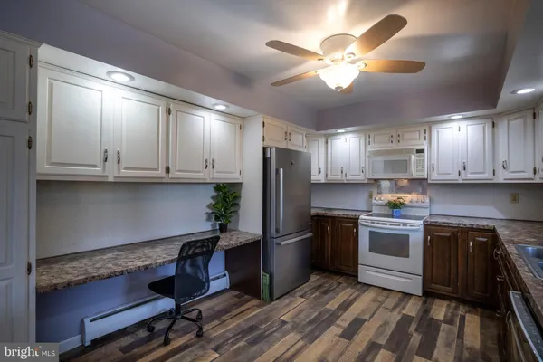 a kitchen with cabinets and stainless steel appliances
