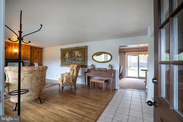a view of a dining room with furniture a chandelier and wooden floor