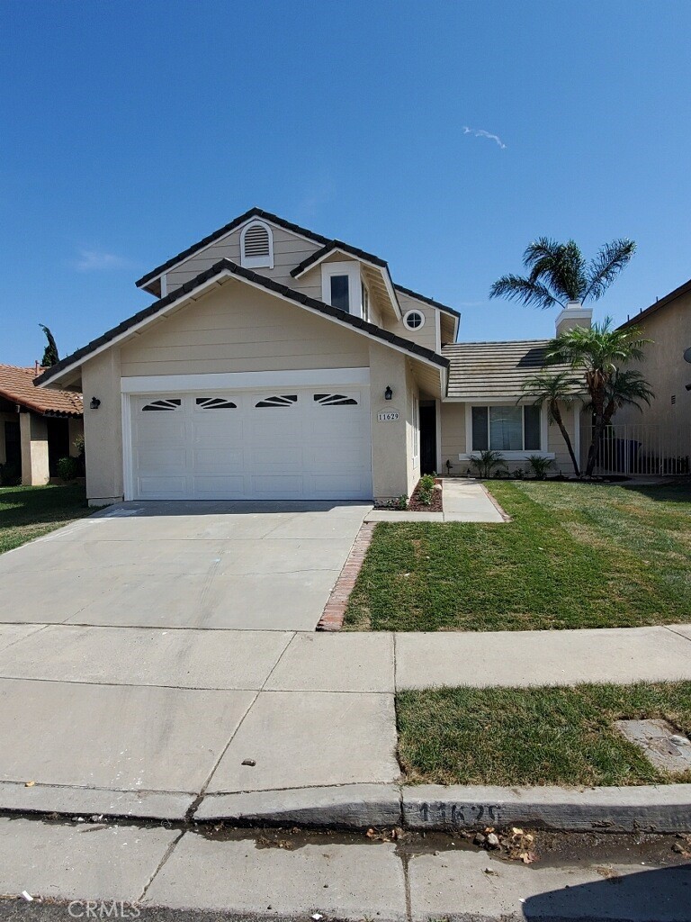 11629 Mt Jefferson Drive Rancho Cucamonga, CA 91737 - Photo 1 of 17 a front view of a house with a yard