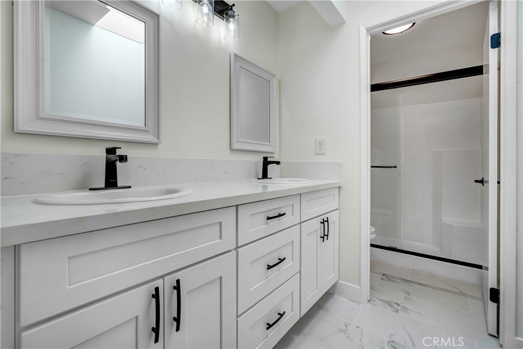 11629 Mt Jefferson Drive Rancho Cucamonga, CA 91737 - Photo 13 of 17 a bathroom with a double vanity sink and mirror
