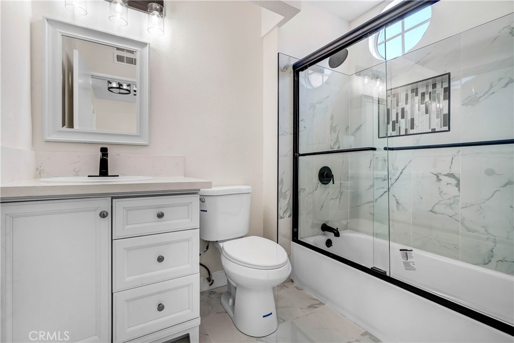 11629 Mt Jefferson Drive Rancho Cucamonga, CA 91737 - Photo 16 of 17 a bathroom with a shower sink vanity mirror and toilet