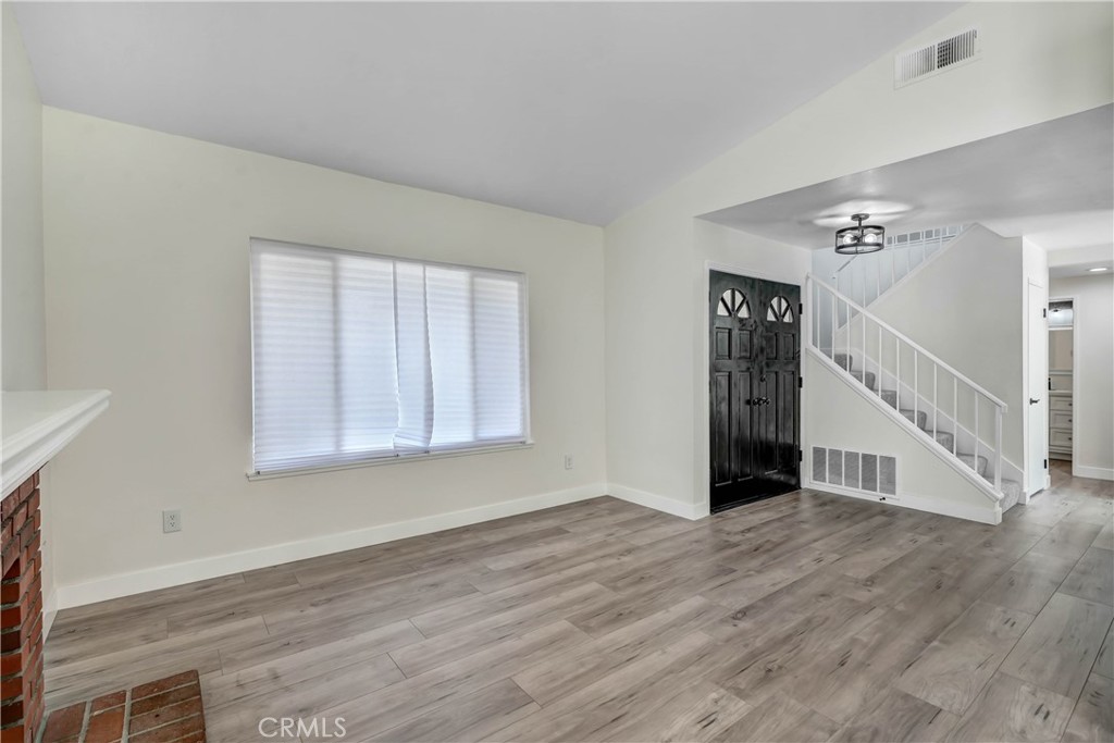 11629 Mt Jefferson Drive Rancho Cucamonga, CA 91737 - Photo 6 of 17 a view of an empty room with wooden floor and a window
