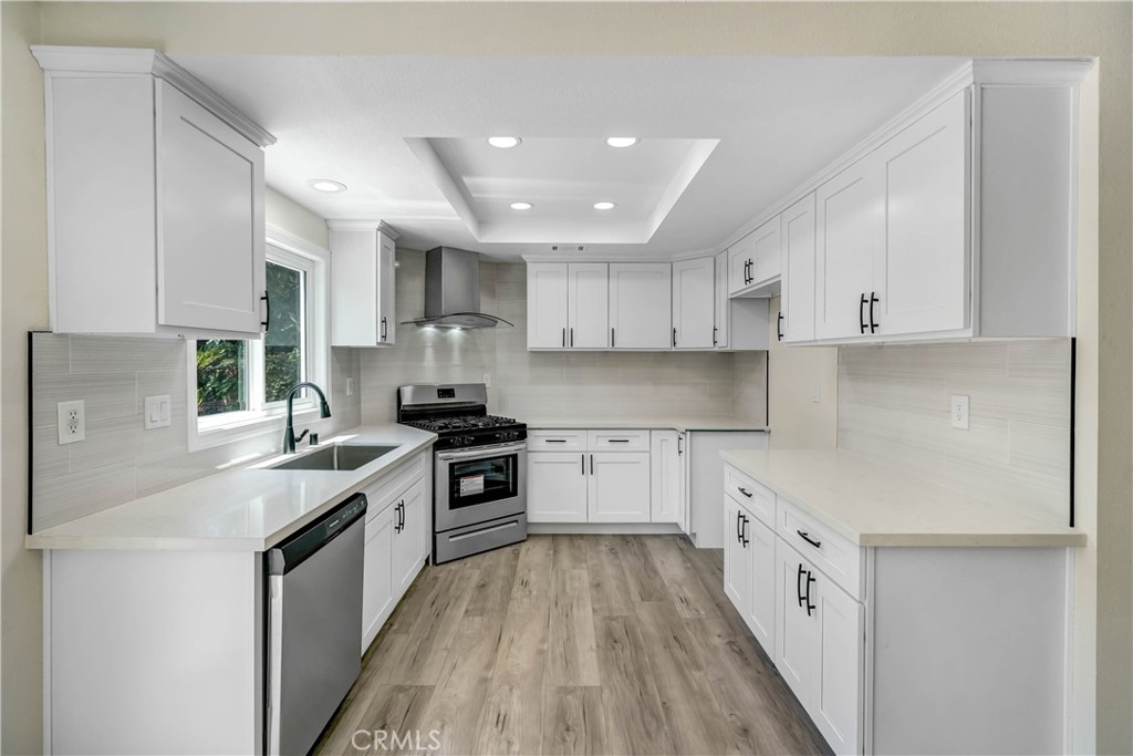 11629 Mt Jefferson Drive Rancho Cucamonga, CA 91737 - Photo 9 of 17 a kitchen with cabinets wooden floor and stainless steel appliances