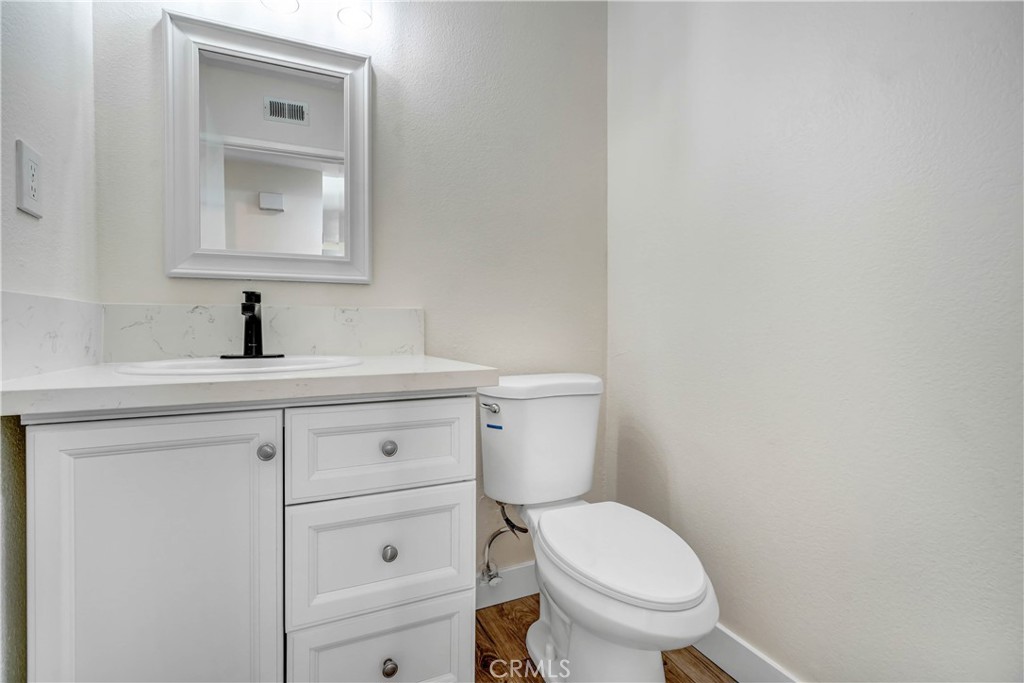 11629 Mt Jefferson Drive Rancho Cucamonga, CA 91737 - Photo 10 of 17 a bathroom with a toilet a sink and mirror