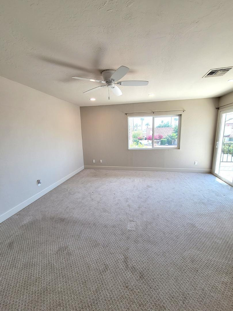 5770 North Scottsdale Road Paradise Valley, AZ 85253 - Photo 11 of 25 an empty room with windows and ceiling fan