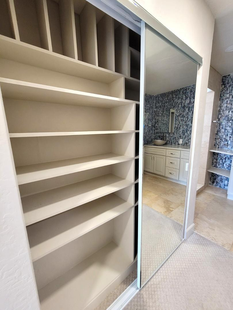 5770 North Scottsdale Road Paradise Valley, AZ 85253 - Photo 17 of 25 a view of walk in closet with clothes and shoes