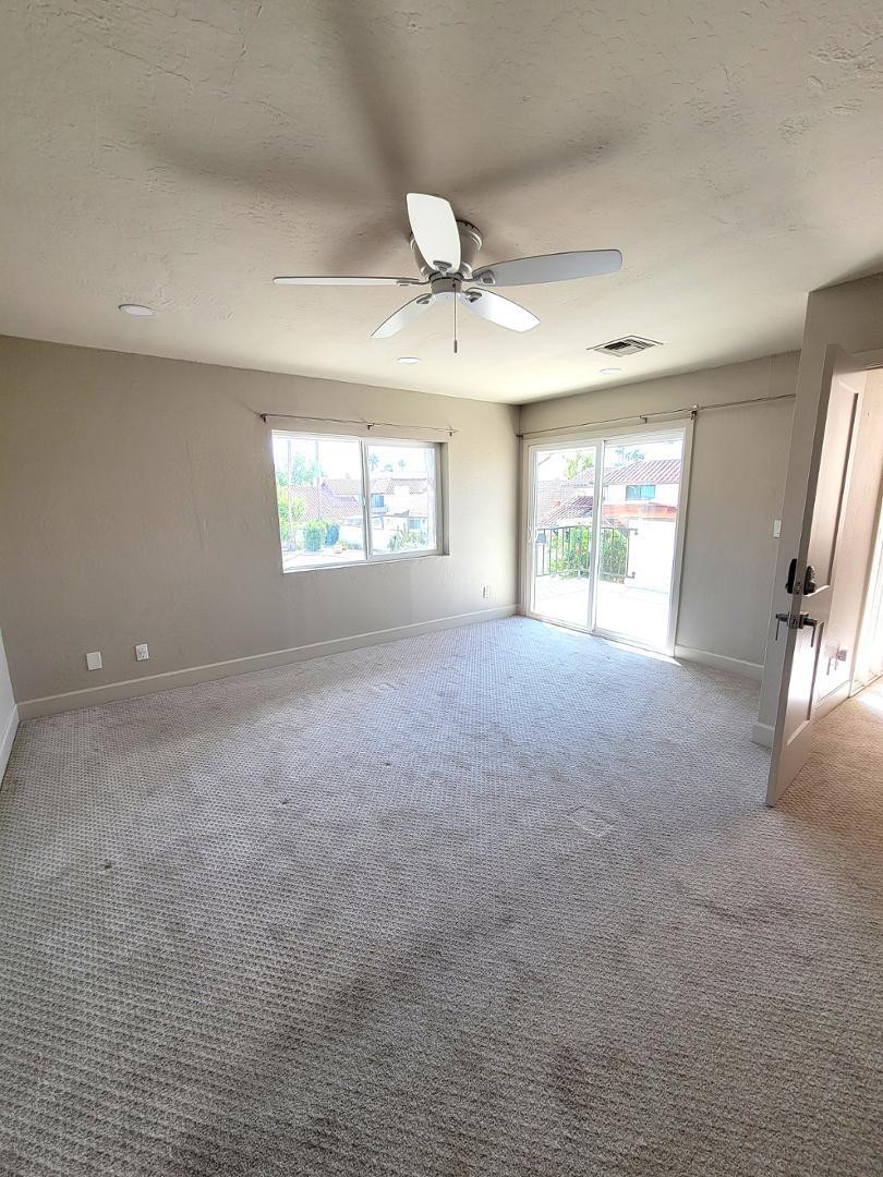 5770 North Scottsdale Road Paradise Valley, AZ 85253 - Photo 19 of 25 an empty room with windows and ceiling fan
