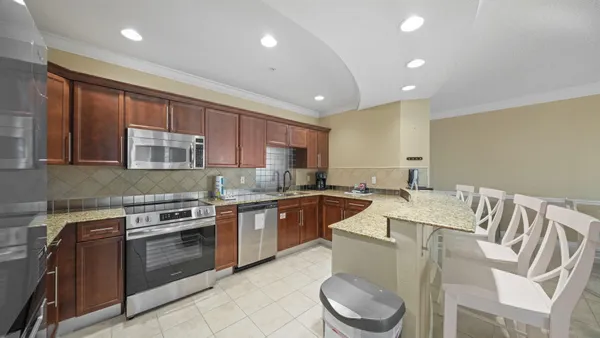 a kitchen with a stove a sink and a refrigerator