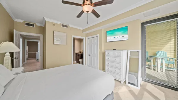 a bedroom with a large bed and a chandelier
