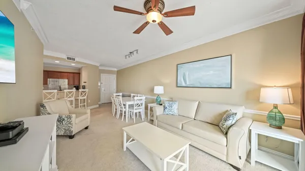 a living room with furniture and a chandelier