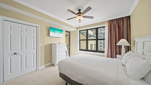 a bedroom with a bed and a chandelier