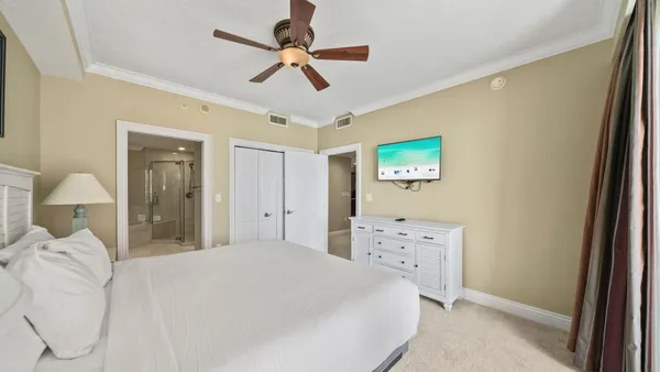 a bedroom with a bed and a large window