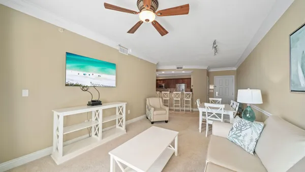 a living room with furniture a ceiling fan and a rug