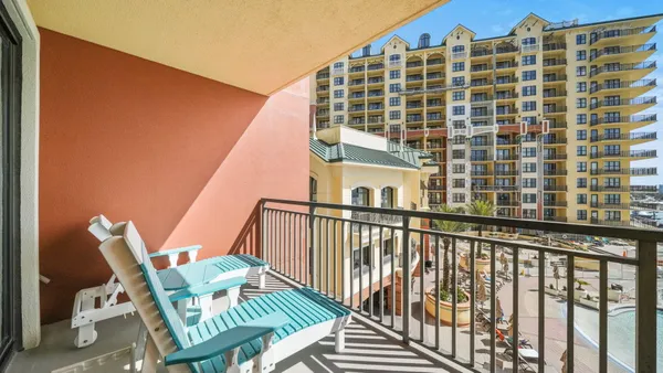 a view of balcony with floor to ceiling windows