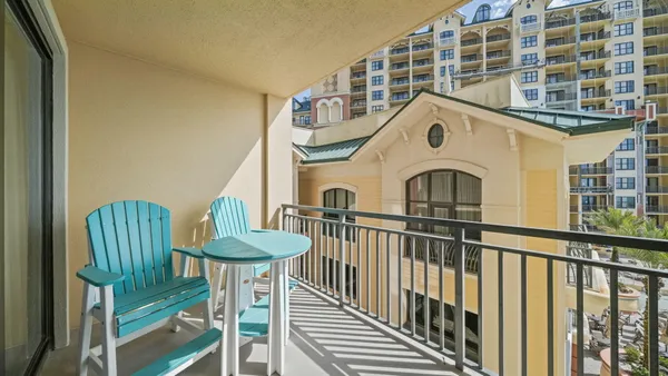 a view of a chair and table in the balcony